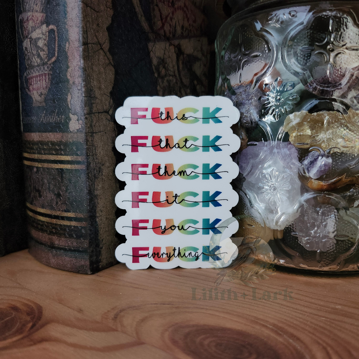 Vinyl sticker with text that says "Fuck this, Fuck that, Fuck them, Fuck it, Fuck you, Fuck Everything" in rainbow ombre colors.